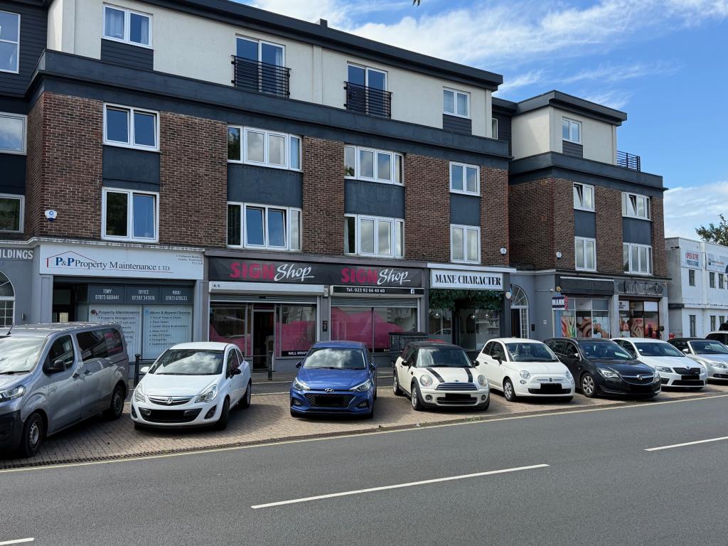 Lot: 96 - MULTIPLE UNIT COMMERCIAL INVESTMENT - View of the parage of shops from the centre